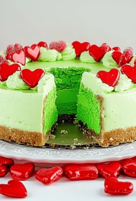 Irresistibly Fun Grinch-Inspired Christmas Cheesecake with Hearts 7 Grinch-Inspired Christmas Cheesecake with Green Filling & Candy Hearts